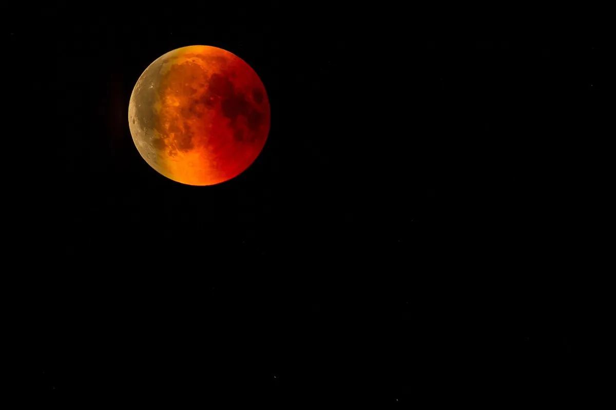 A total lunar eclipse showing the Moon glowing deep red against a dark sky