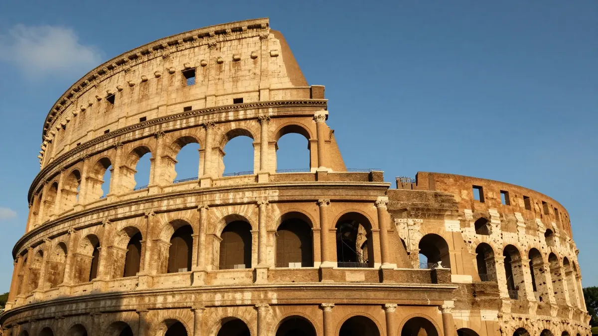 The Roman Colosseum at golden hour with warm light on its ancient stone arches