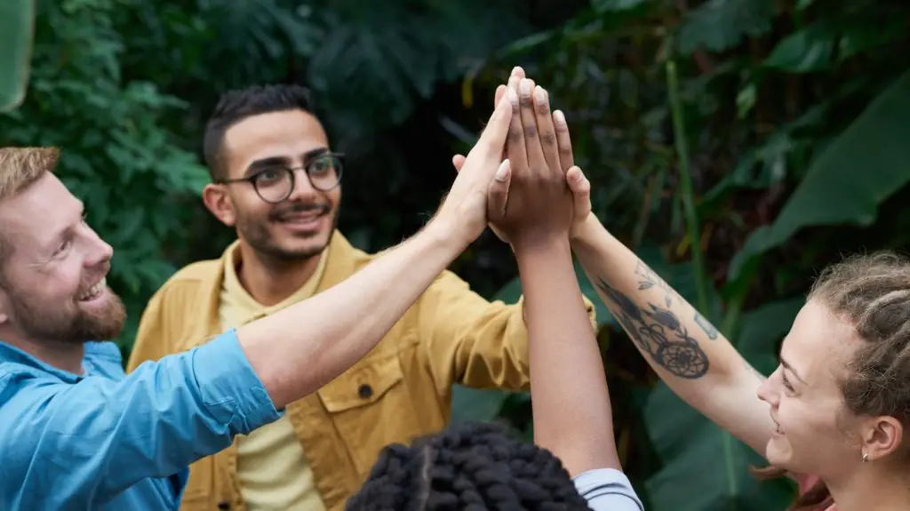 Photo Of People Putting Their Hands Up