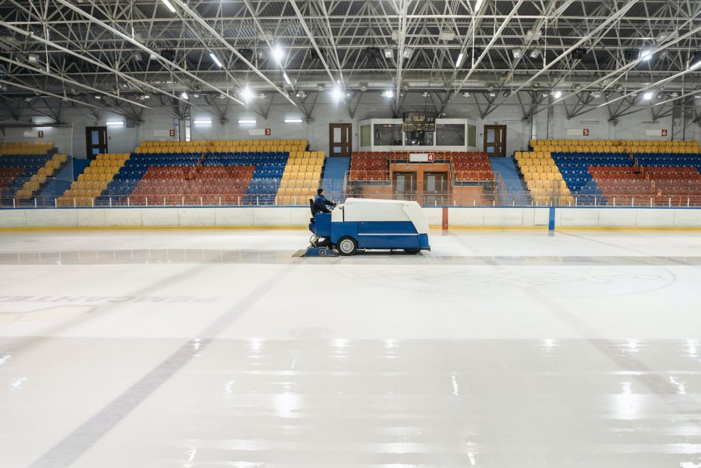 Person Riding A Zamboni On An Ice Skating Rink