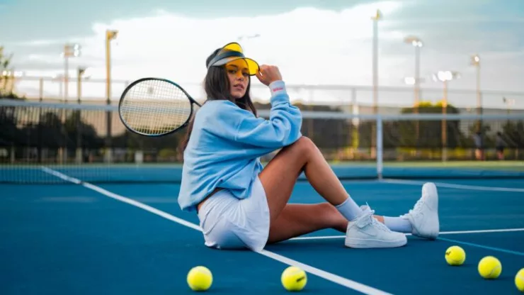 Woman In Blue Dress Sitting On Tennis Court